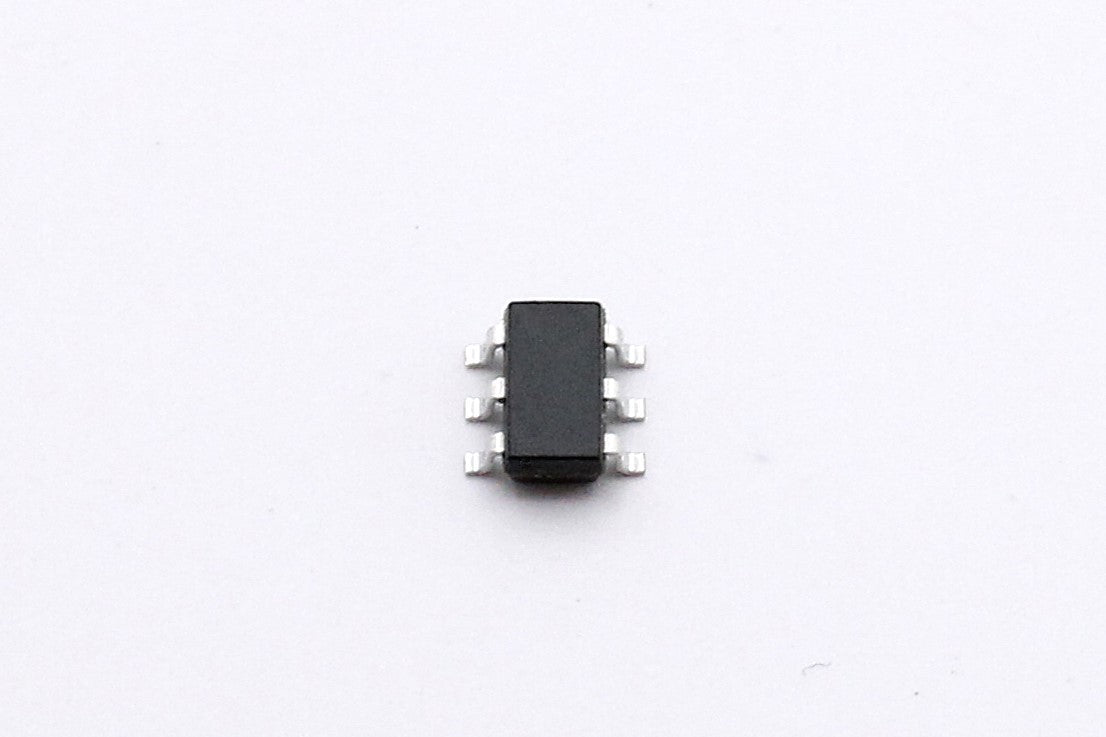 Close-up of a PADAUK PMS150C-U06 microcontroller showing the six leads of its SOT23-6 package